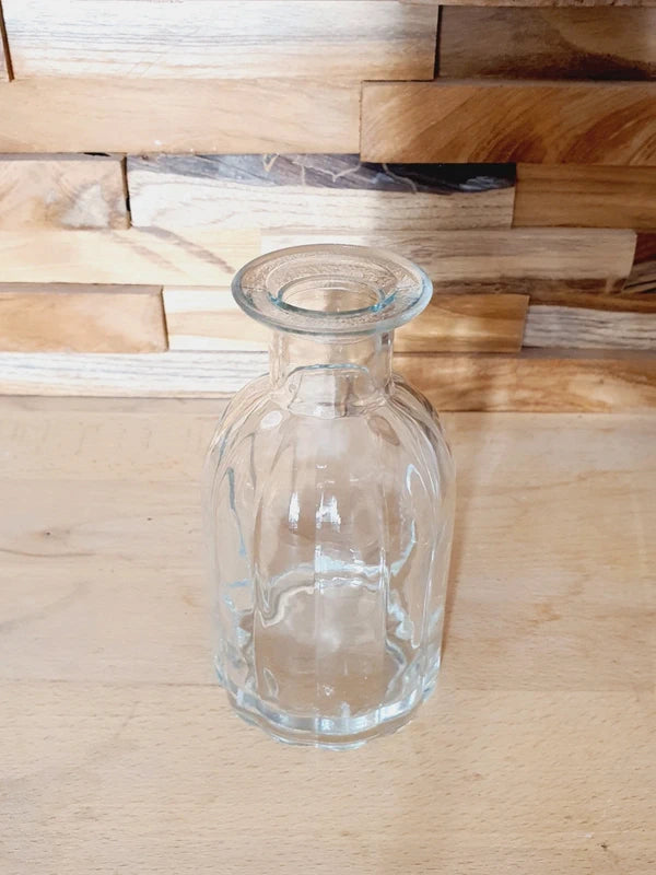 Petit vase soliflore cylindrique en verre transparent massif avec une base large et stable, design épuré des années 1970.