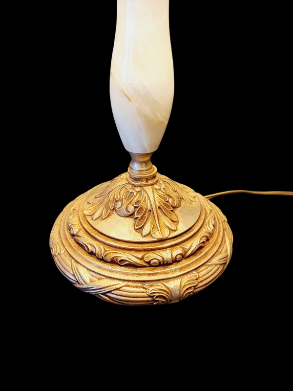 Grande lampe à poser rétro avec pied sculpté en albâtre blanc veiné et monture en laiton doré, surmontée d'un large abat-jour crème à franges.