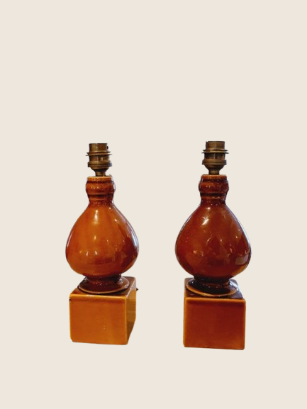 Paire de pieds de lampe céramique de couleur marron terre, style poterie Vallauris ancienne des années 70. Présentés sur un fond clair, montrant leur texture brute et leur forme cubique à la base.