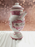Chevrette à pharmacie ancienne en faïence d'art de Clamecy blanche et rose framboise avec son couvercle d'origine, de style XVIIIe siècle.