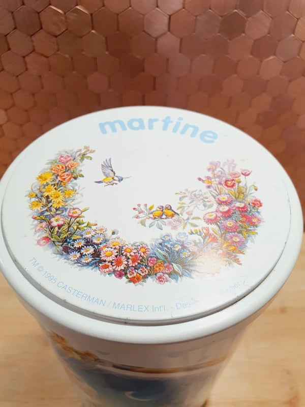 Lot de deux anciennes boîtes à biscuits cylindriques en métal lithographié de l'univers de l'héroïne de livres Martine, illustrations de Marcel Marlier datant des années 1990, parfaites pour le rangement décoratif de la chambre d'enfant.