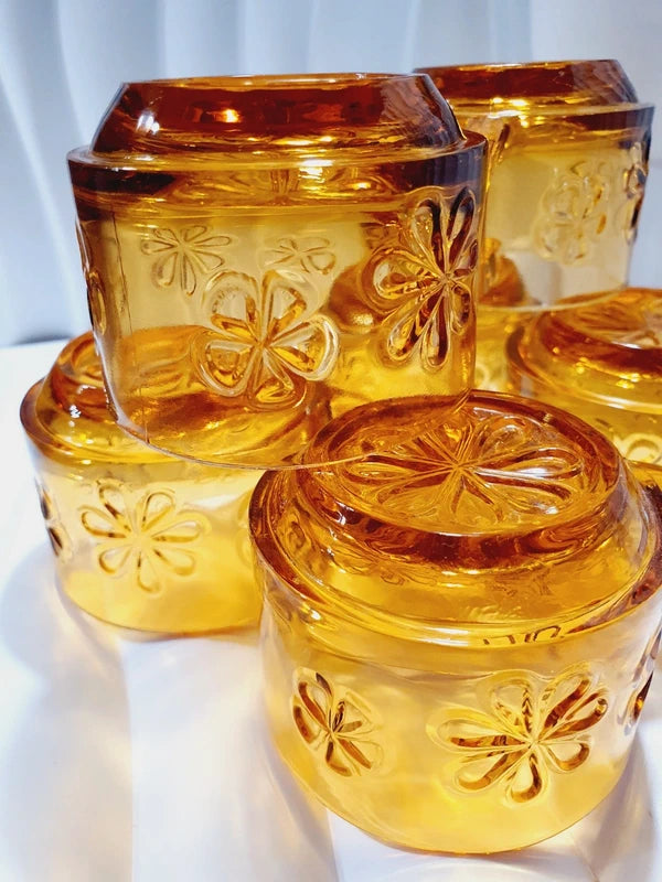 Lot de six tasses à café espresso empilables en verre trempé ambré transparent, ornées d'un motif de fleurs marguerites "Daisy" moulé en relief, marque Vereco France époque années 1970.